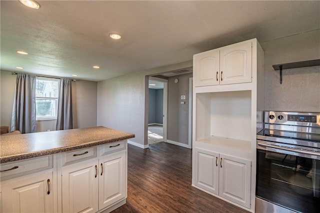 kitchen featuring dark wood-type flooring, oven, white cabinetry, and recessed lighting