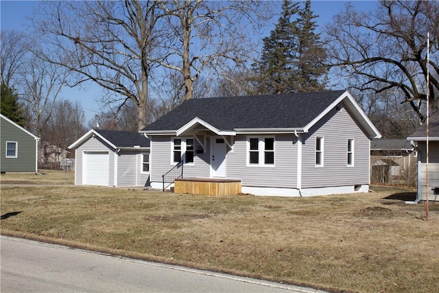 view of front of property with roof with shingles, an outdoor structure, and a front lawn