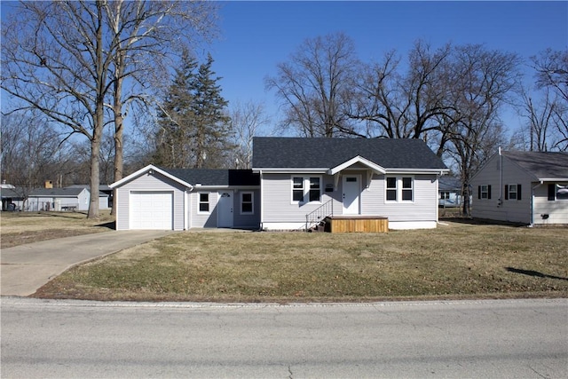 view of front of house with a front lawn, a garage, driveway, and a shingled roof