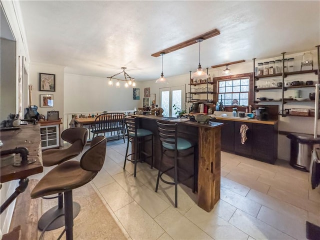 10 Rose Ln, Marshall, IL 62441 - kitchen featuring a breakfast bar area, pendant lighting, a center island, dark countertops, and a chandelier