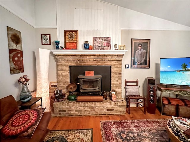 10 Rose Ln, Marshall, IL 62441 - living room with wood finished floors, a wood stove, and vaulted ceiling