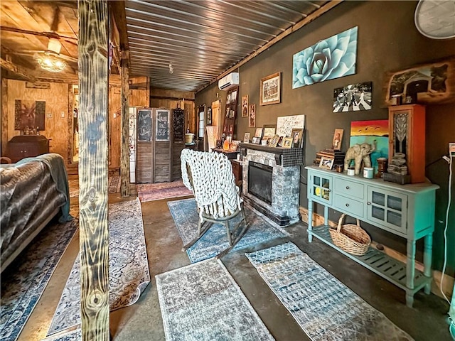 10 Rose Ln, Marshall, IL 62441 - home office with concrete flooring, a fireplace, wooden walls, and a wall unit AC