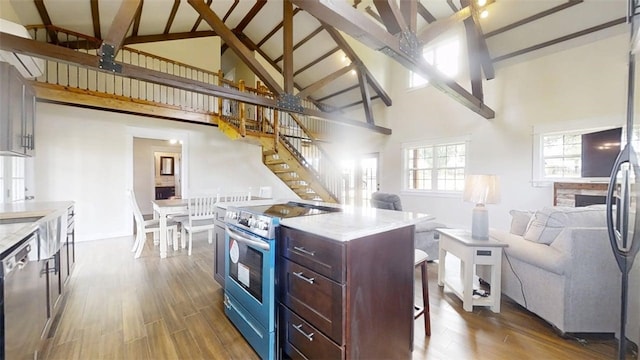 67 Shores, Sullivan, IL 61951 - kitchen featuring stainless steel appliances, open floor plan, high vaulted ceiling, beam ceiling, and dark wood finished floors