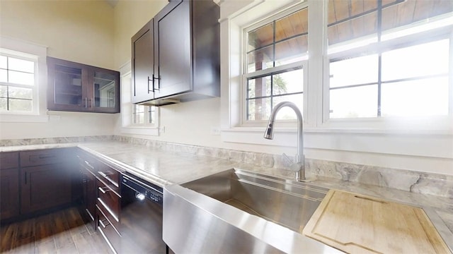 67 Shores, Sullivan, IL 61951 - kitchen featuring black dishwasher, light countertops, glass insert cabinets, and a sink