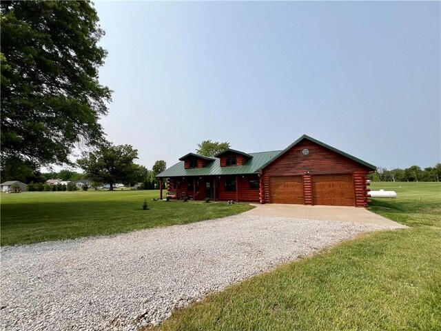 67 Shores, Sullivan, IL 61951 - log-style house featuring gravel driveway, an attached garage, a front yard, and metal roof