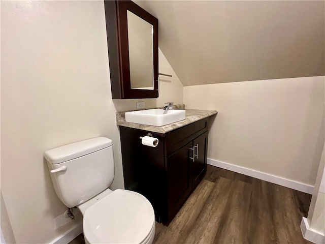 67 Shores, Sullivan, IL 61951 - bathroom with vanity, toilet, wood finished floors, vaulted ceiling, and baseboards