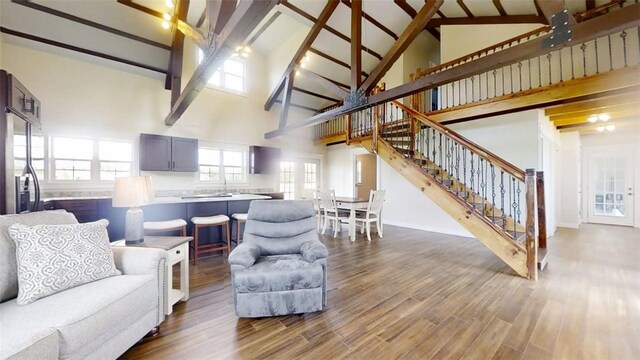 67 Shores, Sullivan, IL 61951 - living area featuring high vaulted ceiling, stairs, beamed ceiling, dark wood-style floors, and baseboards