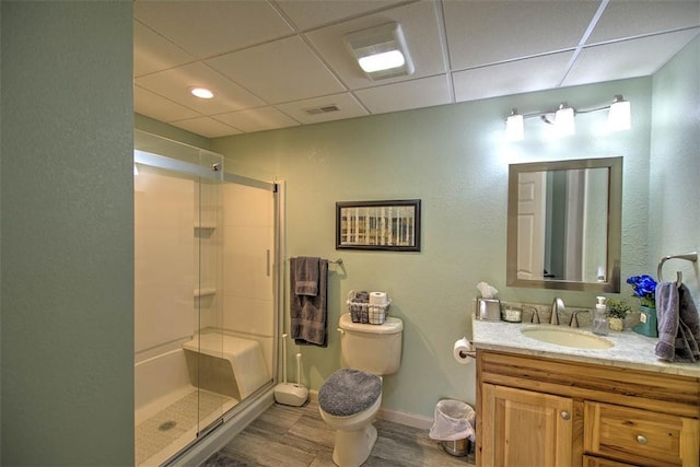 8898 Country Side Dr, Dalton City, IL 61925 - bathroom featuring a drop ceiling, a shower stall, vanity, and wood finished floors
