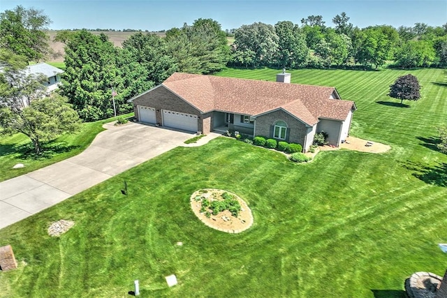 8898 Country Side Dr, Dalton City, IL 61925 - view of front facade with a garage, concrete driveway, a front yard, a chimney, and view of scattered trees