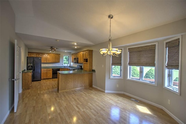 8898 Country Side Dr, Dalton City, IL 61925 - kitchen featuring black appliances, a peninsula, brown cabinets, healthy amount of natural light, and lofted ceiling