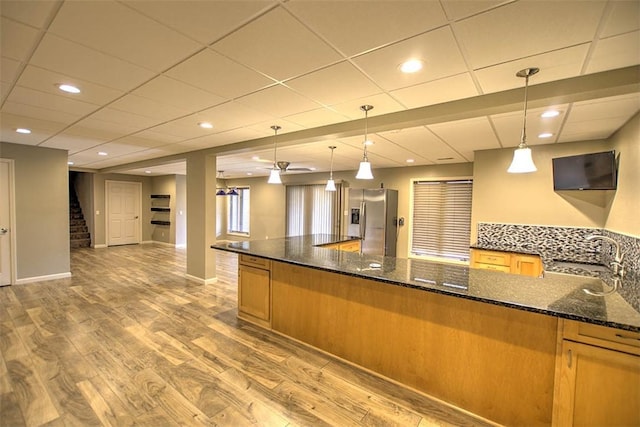 8898 Country Side Dr, Dalton City, IL 61925 - kitchen with light wood finished floors, dark stone countertops, stainless steel refrigerator with ice dispenser, hanging light fixtures, and a drop ceiling