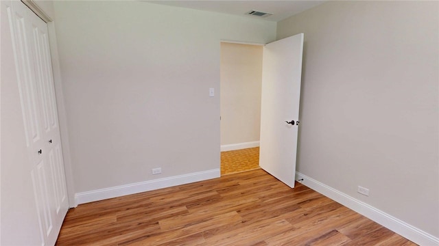 2550 Ivy Ln, Decatur, IL 62521 - unfurnished bedroom with light wood-type flooring and a closet