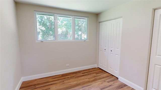 2550 Ivy Ln, Decatur, IL 62521 - unfurnished bedroom featuring light wood-type flooring and a closet