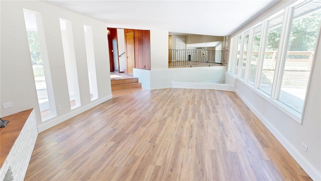 2550 Ivy Ln, Decatur, IL 62521 - unfurnished living room with light wood-style flooring and baseboards