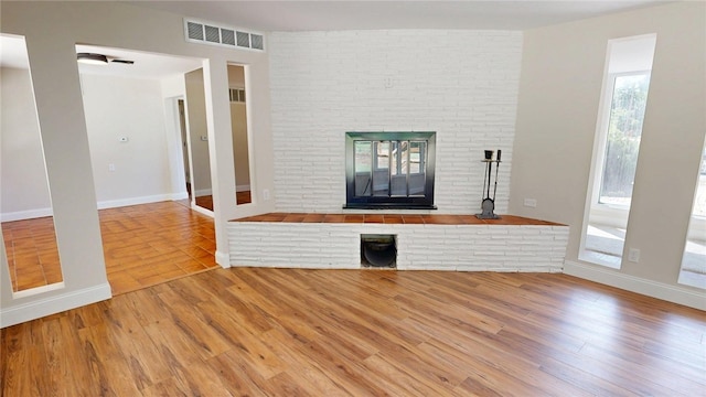 2550 Ivy Ln, Decatur, IL 62521 - unfurnished living room with wood finished floors and a brick fireplace