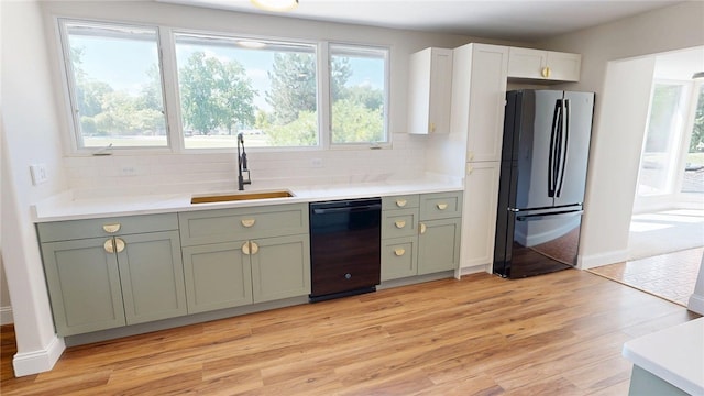 2550 Ivy Ln, Decatur, IL 62521 - kitchen with freestanding refrigerator, dishwasher, tasteful backsplash, and plenty of natural light