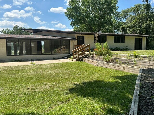 2550 Ivy Ln, Decatur, IL 62521 - rear view of property with a sunroom and a yard