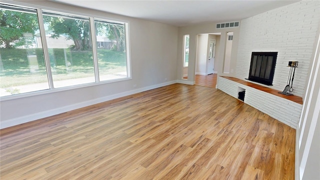 2550 Ivy Ln, Decatur, IL 62521 - unfurnished living room with light wood-style floors and a fireplace