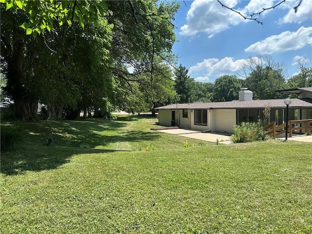 2550 Ivy Ln, Decatur, IL 62521 - view of grassy yard featuring a patio area