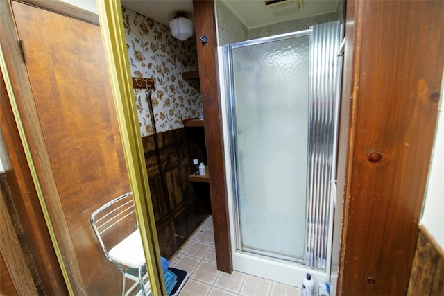 bathroom featuring a shower with shower door