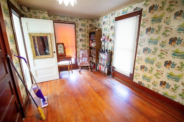 miscellaneous room featuring hardwood / wood-style flooring and a textured ceiling