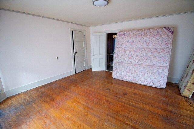 unfurnished bedroom featuring hardwood / wood-style flooring