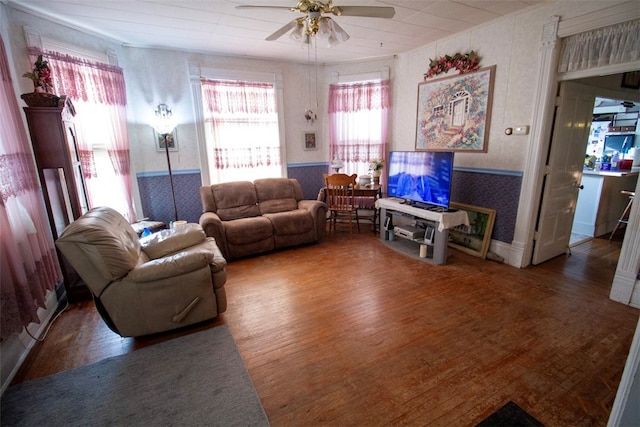 living room with hardwood / wood-style flooring and ceiling fan