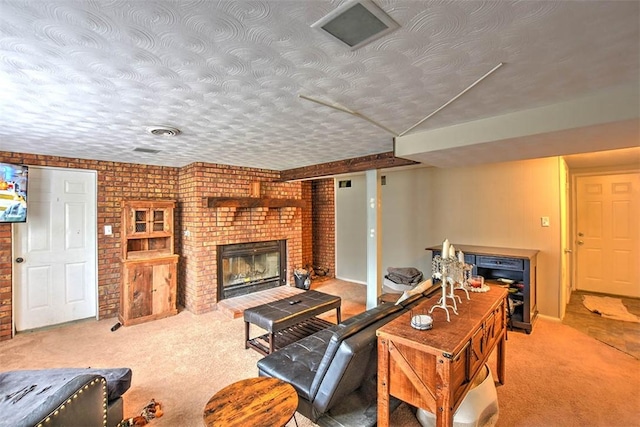 carpeted living room featuring a fireplace, a textured ceiling, and brick wall