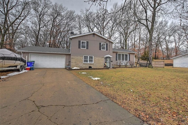 split level home featuring a garage and a front lawn