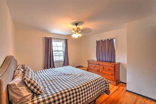 bedroom with ceiling fan and light hardwood / wood-style flooring