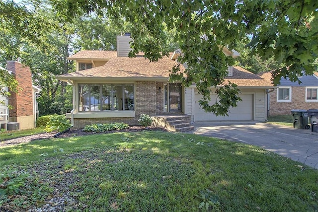 664 N Antler Dr, Mt Zion, IL 62549 - view of front facade featuring driveway, a front yard, a garage, and a chimney