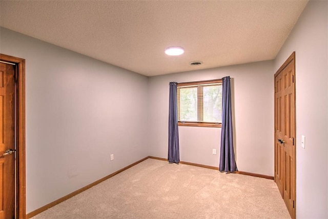 664 N Antler Dr, Mt Zion, IL 62549 - unfurnished bedroom with light carpet and a textured ceiling