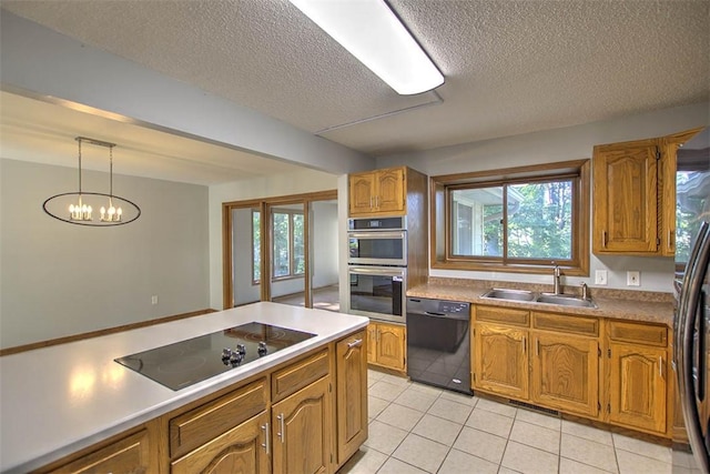 664 N Antler Dr, Mt Zion, IL 62549 - kitchen with black appliances, light tile patterned floors, a textured ceiling, brown cabinetry, and plenty of natural light