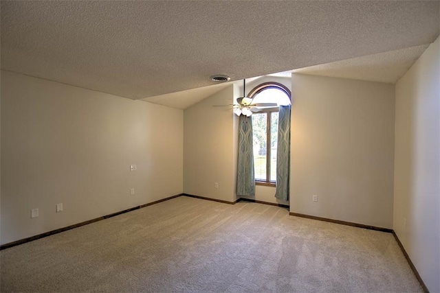 664 N Antler Dr, Mt Zion, IL 62549 - spare room with light colored carpet, a textured ceiling, a ceiling fan, and vaulted ceiling