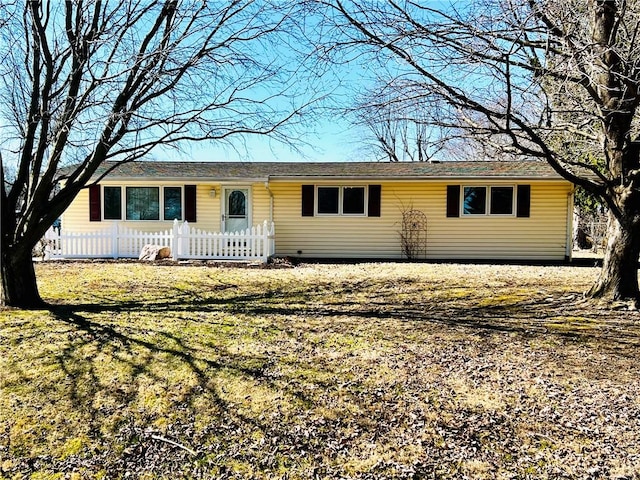 ranch-style house with a fenced front yard