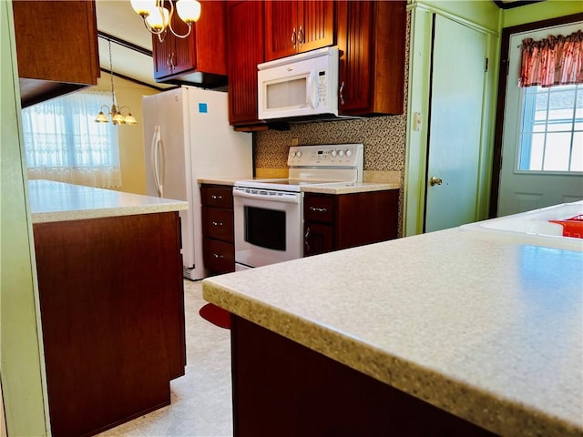 kitchen with white appliances, tasteful backsplash, light countertops, light floors, and a notable chandelier