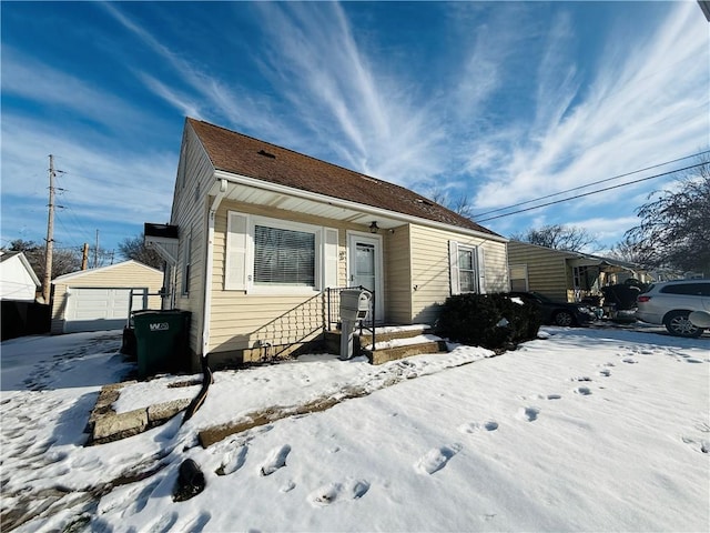 view of front facade with an outbuilding and a garage