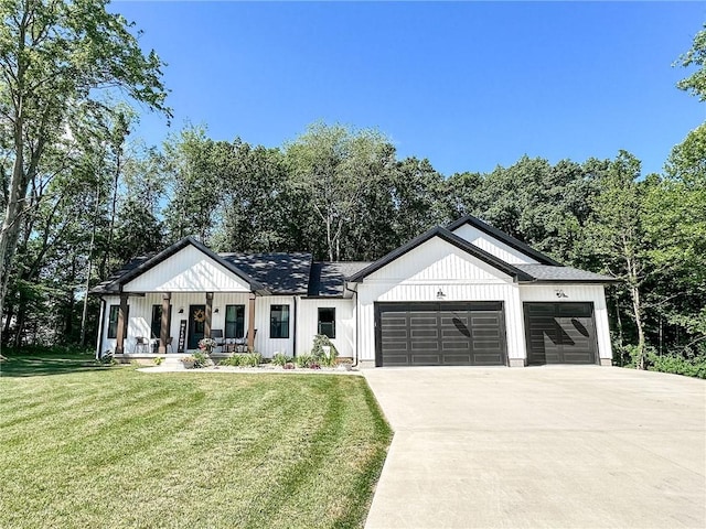 3 Wood Ridge Ln, Marshall, IL 62441 - modern farmhouse featuring a garage, driveway, a front yard, and covered porch