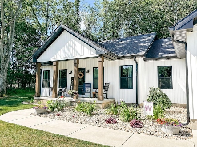 3 Wood Ridge Ln, Marshall, IL 62441 - modern farmhouse style home with a porch, a shingled roof, and a front lawn