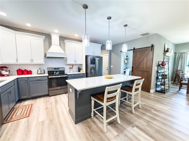 3 Wood Ridge Ln, Marshall, IL 62441 - kitchen featuring stainless steel appliances, custom exhaust hood, a barn door, a kitchen breakfast bar, and gray cabinets