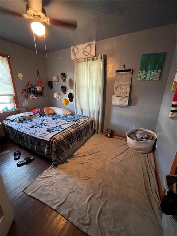 bedroom with hardwood / wood-style flooring and ceiling fan