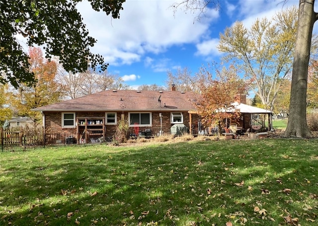 back of house featuring a yard