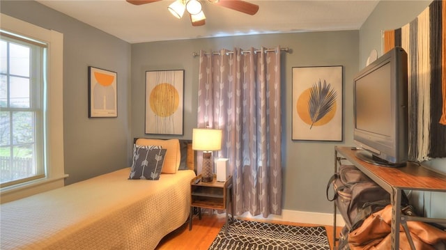 bedroom with baseboards and wood finished floors