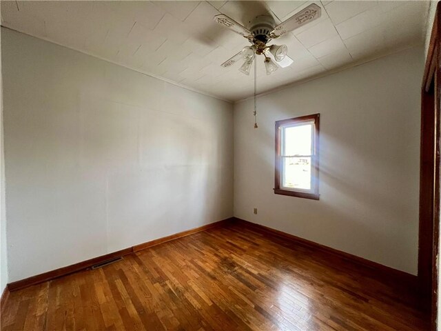 spare room featuring ceiling fan and dark wood-type flooring