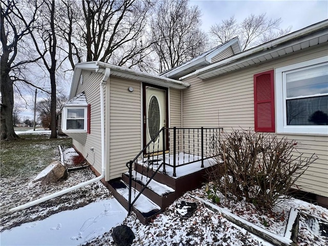 view of snow covered property entrance