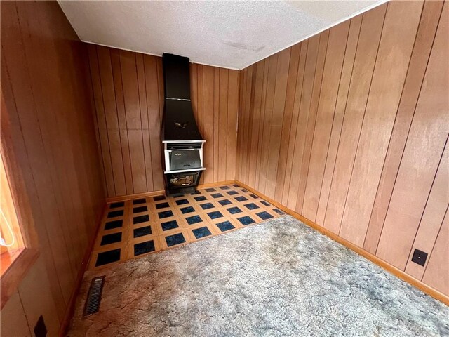 interior space featuring wood walls and a textured ceiling