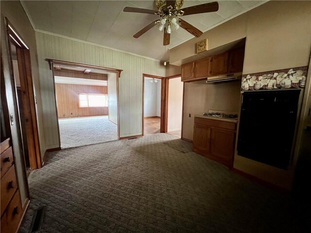 kitchen with carpet floors, white gas cooktop, ceiling fan, and ornamental molding