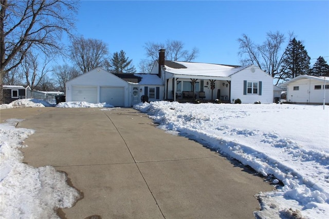 ranch-style home with covered porch and a garage