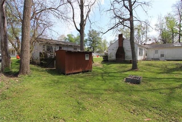 1034 9th St, Charleston, IL 61920 - view of green lawn with a storage unit
