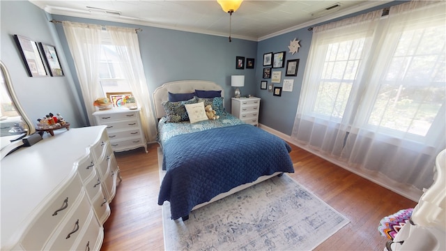 1805 N Gilbert St, Danville, IL 61832 - bedroom featuring crown molding, multiple windows, wood finished floors, and visible vents